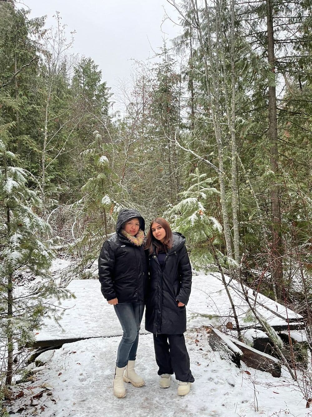 Norma y Camila Díaz, mamá e hija, abrazadas en un bosque nevado de Canadá